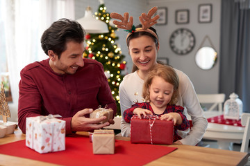 Happy family with Christmas gifts at home