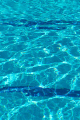 Abstract blurred background of pool water texture. Bright fashionable color of Aqua Menthe water. Vertical, free space. Design concept.