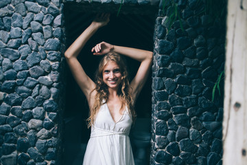 Obraz premium Cheerful charming flirty blond standing in doorway
