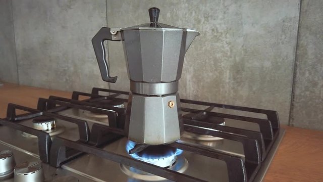geyser coffee heats maker up on a home gas stove, boiling water
