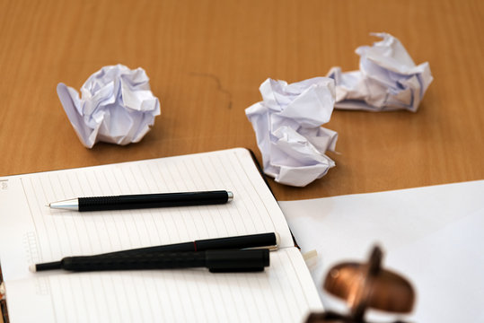 notebook,pen on table side crumpled paper. - Powered by Adobe