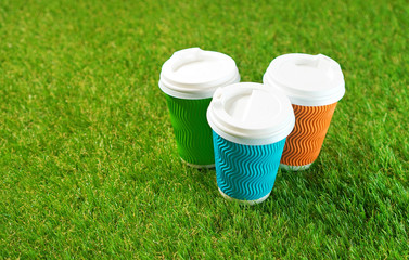 Colorful paper cups on a green artificial turf