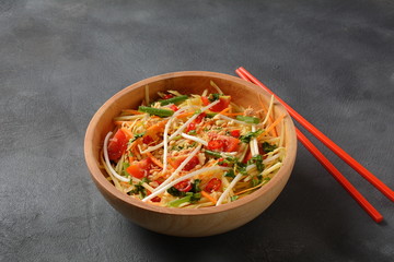 Delicious Som Tam -Thai green papaya salad) with green beans, tomatoes, peanuts. Thai street food . Healthy vegan foodgreen beans, tomatoes, peanuts. Thai street food . Healthy vegan food