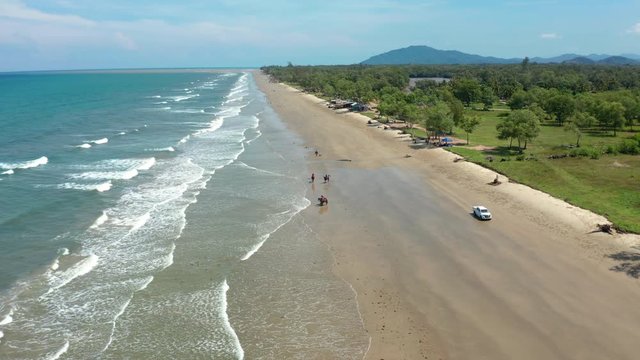 4K Aerial footage view of ocean waves crashing on Beautiful beach by at Sabandar Beach, Tuaran, Sabah, Malaysia