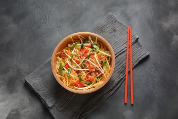Delicious Som Tam -Thai green papaya salad) with green beans, tomatoes, peanuts. Thai street food . Healthy vegan foodgreen beans, tomatoes, peanuts. Thai street food . Healthy vegan food