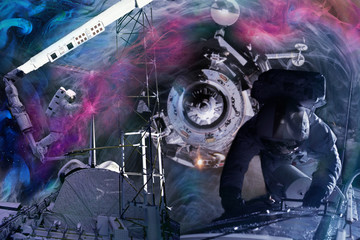 Two astronauts in a spacesuit work at the space station interstellar background, art collage. The...