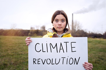 Teenager girl holding placard during global strike for climate change     