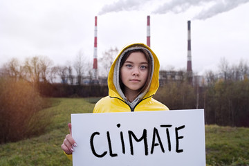 Teenager girl holding placard during global strike for climate change     