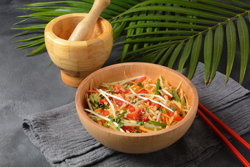 Delicious Som Tam -Thai green papaya salad) with green beans, tomatoes, peanuts. Thai street food . Healthy vegan foodgreen beans, tomatoes, peanuts. Thai street food . Healthy vegan food