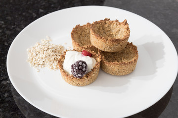 Homemade recipe made with oat flakes and natural yogurt filling, berries. Delicious and healthy breakfast snack preparation