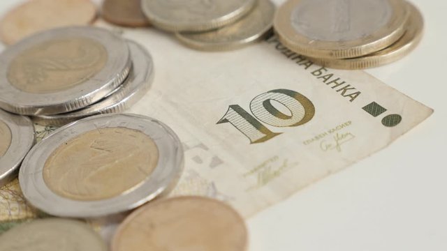 Lot of coins on top of the Bulgarian lev banknote 4K video