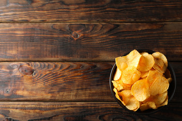 Potato chips. Beer snacks on wooden background, space for text. Top view