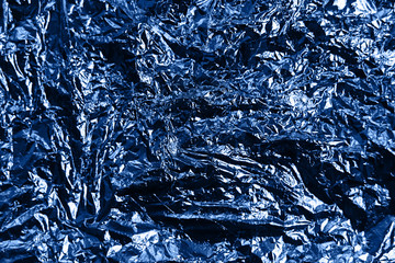 Metallic wrapping paper. Classic blue color of the year 2020. Overlapping glowing and twinkling...