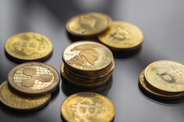 Stack of golden Titan bitcoin coin with a lot of bitcoins coins on a table. Virtual cryptocurrency concept. Mining of bitcoins online bussiness. Bitcoins trading.