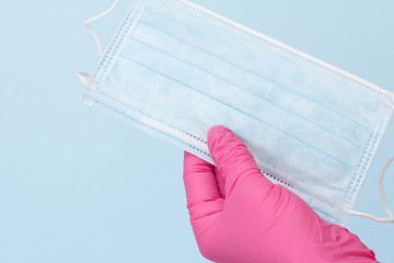 Dentist's hand in glove with protective mask.