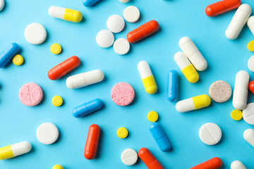 Different pills on blue background, top view. Health care