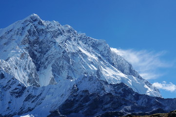 Fototapeta na wymiar The top of snow-covered mount in the background of blue sky in the Himalayan mountains. Nepal.