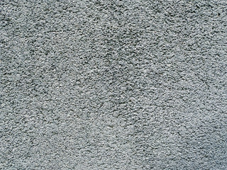 Rough texture of an old grey wall with visible pattern of applying the cement and other materials on an old and aged building