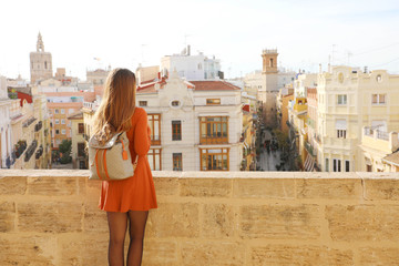 Visiting Valencia. Back view of young traveler woman enjoying cityscape of Valencia, Spain.