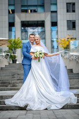 beautiful newlyweds on business center background
