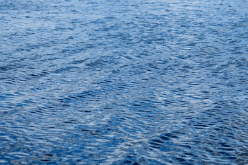 Light playing on the sea surface. Water or Sea surface. Water background. Blue water surface. Abstract blue water. Color of the year 2020.
