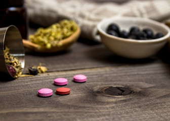Obraz na płótnie Canvas Many different medicinal herbs. Homeopathic pills.