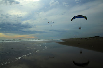 Yogyakarta, Indonesia, March 15, 2015. The action of paragliding athletes who fly past them in the afternoon	