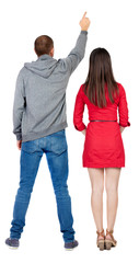 Fototapeta premium Back view of a stylish couple pointing.