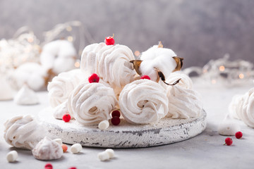 White zephyr on grey concrete background. Set of homemade marshmallow Meringue, pansy. Russian sweetness cusine