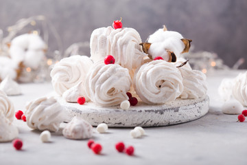 White zephyr on grey concrete background. Set of homemade marshmallow Meringue, pansy. Russian sweetness cusine