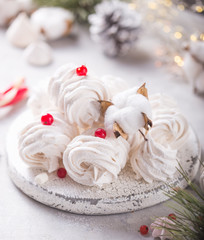 White zephyr on grey concrete background. Set of homemade marshmallow Meringue, pansy. Russian sweetness cusine