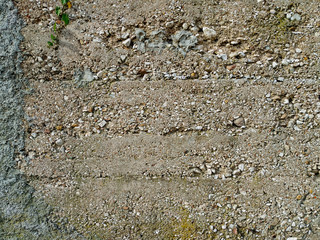 Old looking and worn wall with signs of age and decay that can be found on the buildings in the...