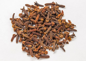 Clove spice. Carnation seasoning. A pile of carnations isolated on a white background.