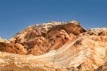 Textured and naturally eroded sandstone rocks with blue sky. Travle and tourism concept. Akamas in Cyprus. Copy space