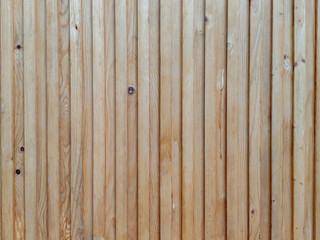 Natural wood texture found on wooden planks making up a wall facade or ground floor in traditional...