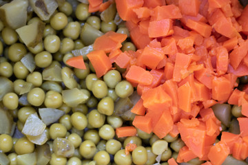 Peas and carrots in salad bowl background