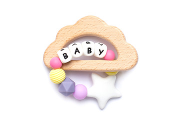 Baby wooden toy and teethers pastel colors on white background