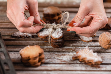 The tradition of celebrating Christmas. A woman is packed gifts from home baking.Closeup.