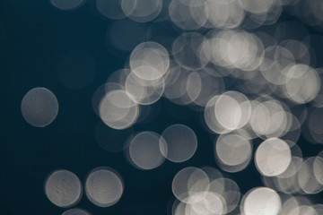 the concept of boating, relaxing at sea - splashes of blue water in the sea close-up. Colorful Bright Stage Lights in a Concert the blurred blue and white light spotlights. boce as background