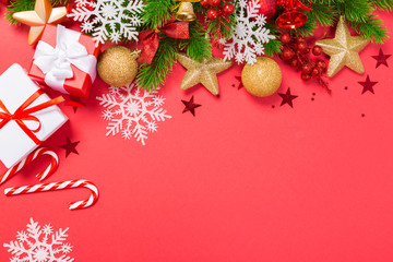 Christmas red background with herringbone and decor. Gold and red jewelry. Top view with space for copy.