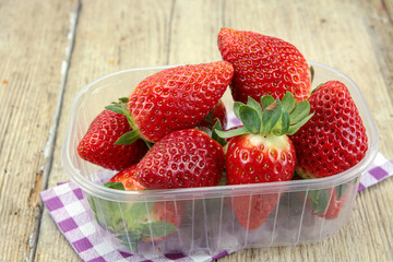 several strawberries on a wooden table