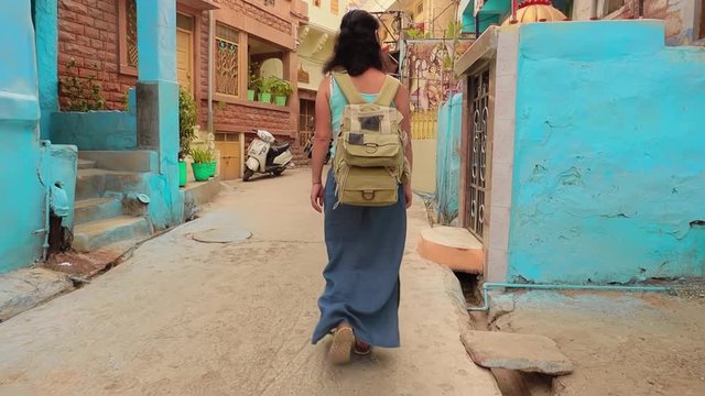 Female tourist walks through the streets of an Indian city. Rajasthan, Indian Jodhpur Also blue city