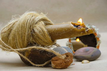 Occult symbolism burning candle, mirror, stones.