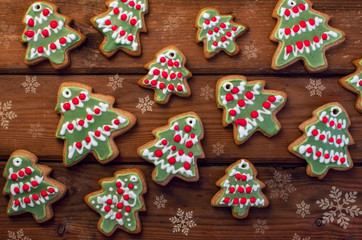 Homemade colorful gingerbread cookies on dark wooden background.