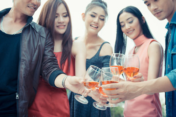 Asia people hands holding glasses of wine making a toast together ,  celebration concept.