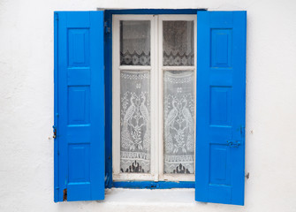 one of the charms of Mykonos, Greek Cycladic island in the heart of the Aegean Sea, are the beautiful colored doors and windows of the houses in the narrow streets of the ancient city