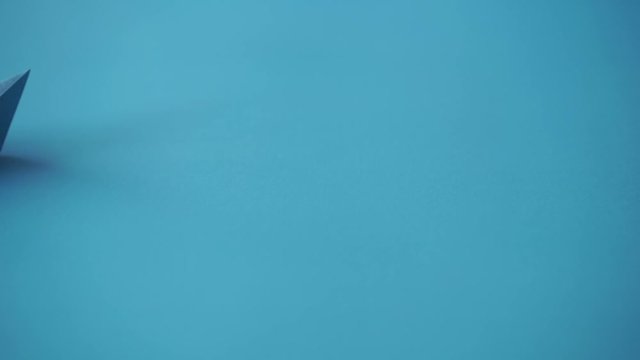 paper boat on clean blue background with copy space, lesson and education concept