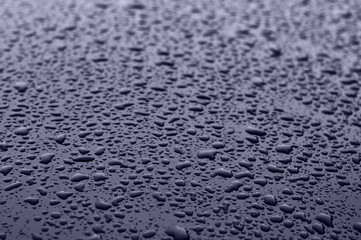 Classic blue pantone color 2020. Texture of water drops on metal. Classic blue background, blue toning 19 4052. Abstract trendy background mock up with copy space for text.