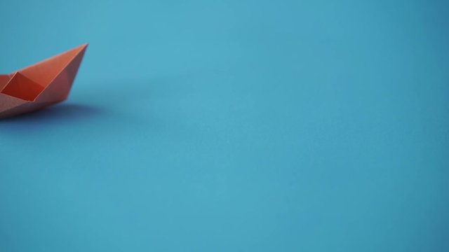 paper boat on clean blue background with copy space, lesson and education concept
