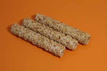 sweet rolls in the nuts on an orange table